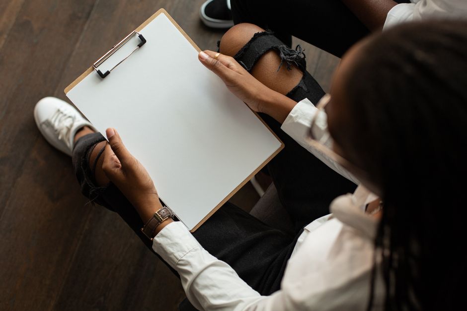 Top view of a person with a blank clipboard, ideal for mockup designs.